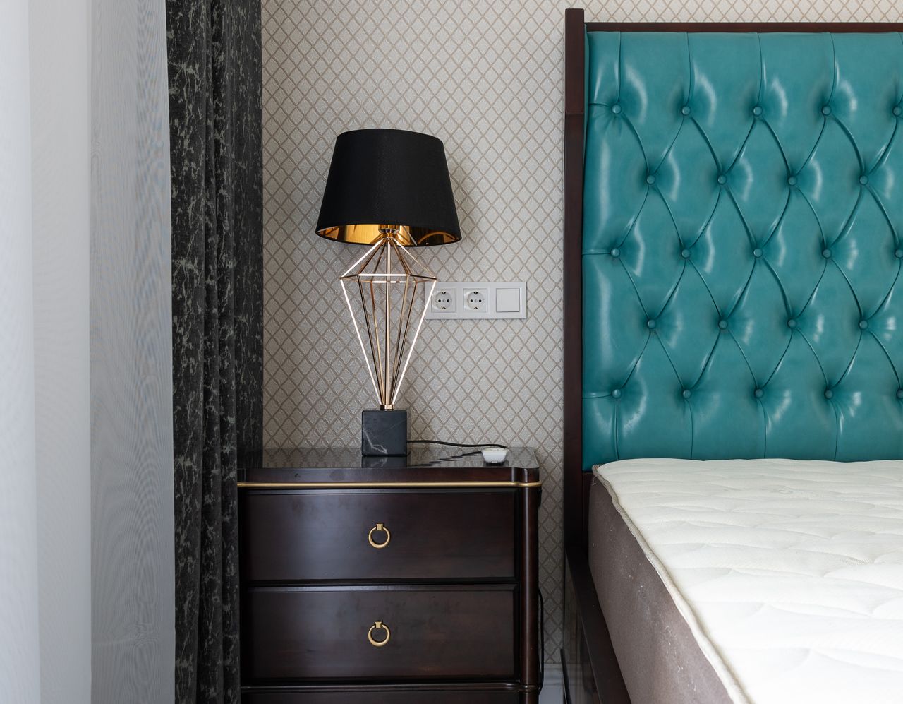 gallery-01 Modern bedroom interior with lamp between mattress on bed with upholstery and curtains at home